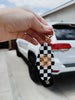Keychain with checkered design and text 